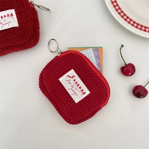 Detail of red corduroy coin purse with keychain showing card storage functionality