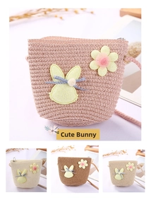 Detailed view of woven textures and cute rabbit patch on children mini straw bucket bags