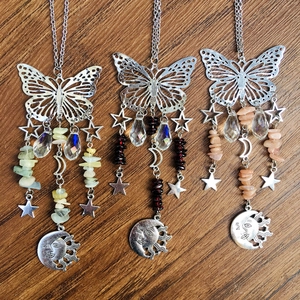 Detail of butterfly suncatchers with silver metal, natural stones and star sun pendants