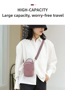 Detail of light purple nylon mini crossbody bag with multiple zippers and adjustable strap