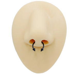 Detailed view of a black stainless steel horseshoe nose ring with sharp cone spikes