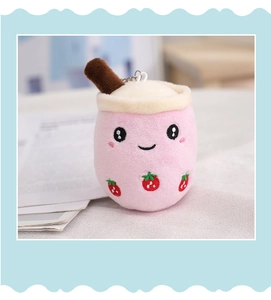 Close-up of pink strawberry milk tea plush keychain with embroidery and metal hook