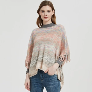 Detail of multi-color ethnic knit poncho showing soft texture and fine fringe tassels