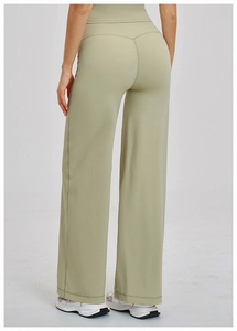 Detail of high-waist yoga pants with V-shaped stitching and loose wide-leg fit in sage green