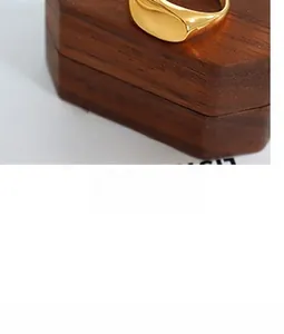 Macro shot of 18K gold plated signet ring showing mirror polished finish and thick texture