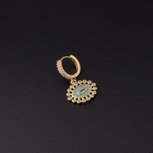 Macro shot of gold Evil Eye hoop earring with blue and clear pavé zircon settings