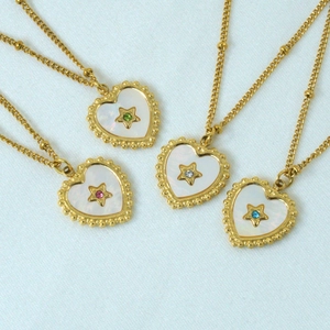 14K gold plated heart shell necklaces with star and colorful crystals on blue fabric