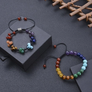 Chakra stone braided bracelet with Tree of Life charm on a black jewelry gift box