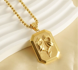 Detail of 18K gold stainless steel pendant with double dragon relief on silk fabric