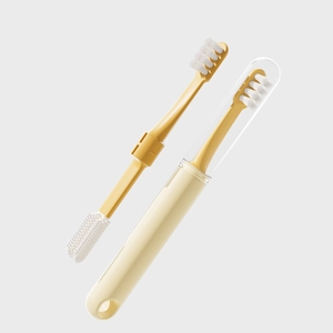 Dual-head yellow pet toothbrush with soft bristles and silicone massager in a cream storage case