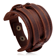Detail of wide brown leather bracelet with multi-layer braided straps and metal snap fasteners