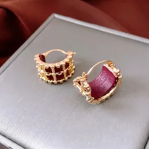 18K gold plated leather hoop earrings with hollow grid design and luxury metal texture