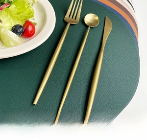 Detail showing waterproof green leather placemat with texture and golden cutlery
