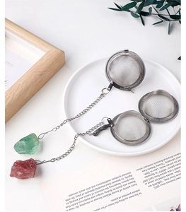 Detailed close-up of SUS304 stainless steel tea infuser with amethyst stone pendant