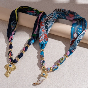 Ethnic style fabric scarf necklace with evil eye elephant and ivory pendants
