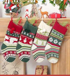 Detailed view of four knitted Christmas stockings with reindeer and snowman patterns