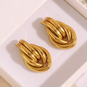 Detail of chunky gold 18K plated stainless steel twisted hoop earrings in white gift box
