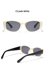 Detailed view of square sunglasses featuring a milky white frame and dark grey lenses