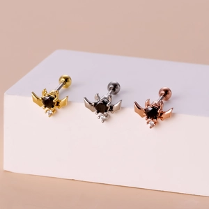 Three-color bat piercing studs in gold, silver, and rose gold with black zircon stones