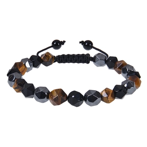 Macro detail of faceted tiger eye and obsidian beads on adjustable braided bracelet