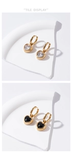 Detailed view of heart-shaped zircon hoop earrings in gold with white and black stone options