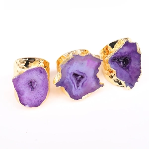 Macro view of purple druzy agate rings with hammered gold-plated brass texture bands