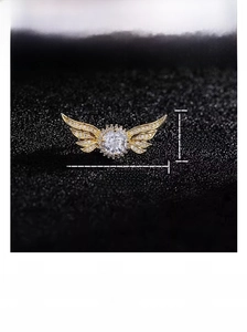 Detail view of gold angel wing brooch with sparkling rhinestones and exact dimensions