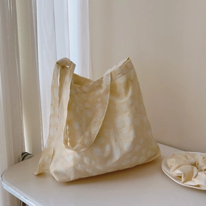 Creamy white pleated cotton tote bag with white polka dots and matching hair scrunchie