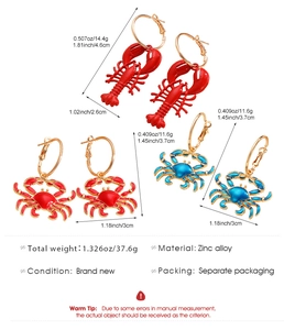 Detailed view of three pairs of ocean-themed alloy drop earrings featuring lobsters and crabs