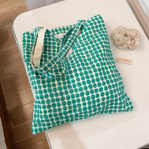 Minimalist cotton tote bag with green geometric patterns and a large capacity shoulder strap