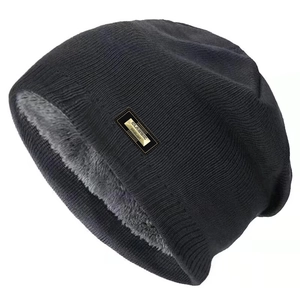 Detail of winter knit beanie showing thick grey fleece lining and classic metal logo tag