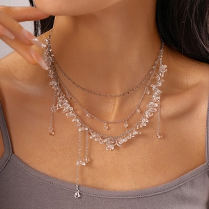 Elegant silver multi-layer fringe necklace with clear resin stones worn by model