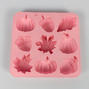 Pink silicone mold with 9 cavities featuring leaf, acorn and pumpkin shapes for DIY