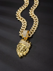 Macro shot of gold lion head pendant with sparkling rhinestones on Cuban chain