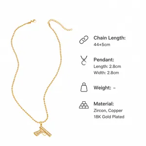Detail view of gold hip hop gun pendant necklace with size specs 2.8x2.8cm