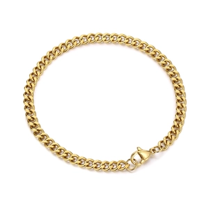 Polished golden stainless steel Cuban link bracelet for men and women on white background