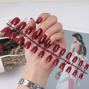 Glossy burgundy long square press-on nails set displayed in a professional row