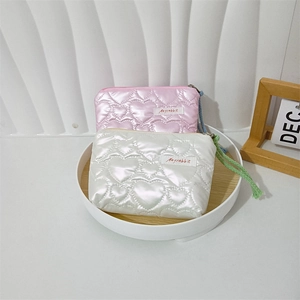 Close-up of heart quilted PU leather cosmetic bags with zipper and woven wrist strap
