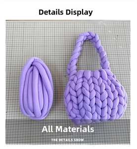 Detail of purple chunky yarn and handmade woven bag kit on a grid cutting mat