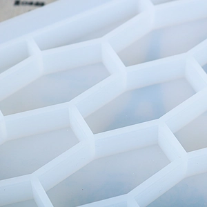 Macro shot of white translucent silicone honeycomb tray mold for resin DIY crafting