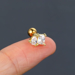 Detailed view of gold ear stud featuring teardrop and square cubic zirconia with screw back