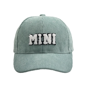 Close-up of MINI embroidery detail on a light green corduroy texture baseball cap