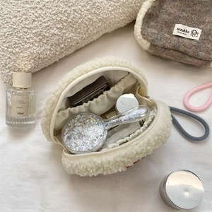 Top view of open plush shell bag showing spacious interior with elastic side pockets