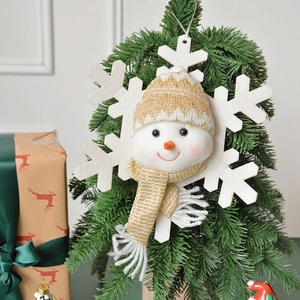 Christmas snowman snowflake plush ornament with gold knit hat on a holiday tree