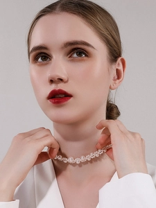 Elegant woven choker style necklace featuring multiple sizes of glossy white pearls