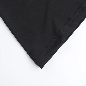 Detail of professional double-needle stitching on black fabric hem for women's set
