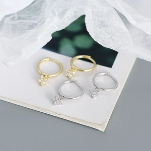 Detailed view of gold and silver butterfly earrings with sparkling cubic zirconia crystals