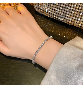 Close-up of sparkling silver tennis bracelet with cubic zirconia on female wrist