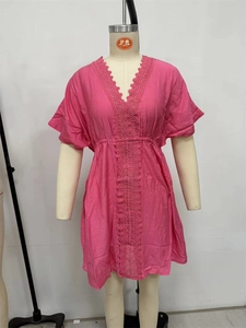 Detail of rose red beach cover-up featuring V-neckline lace trim and drawstring waist