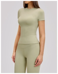 Detail of sage green yoga set with high waist leggings and short sleeve slim fitness top